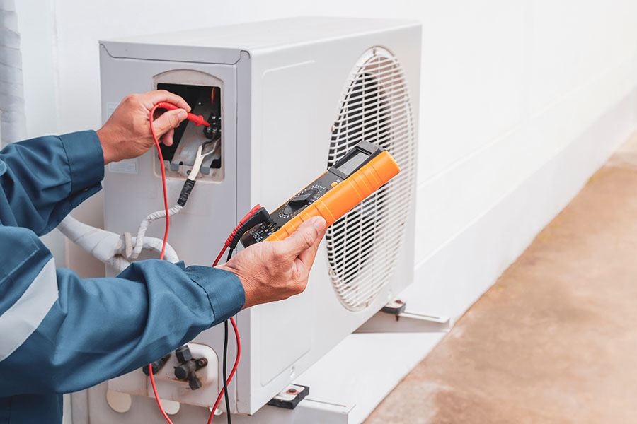 Technician performing AC maintenance task