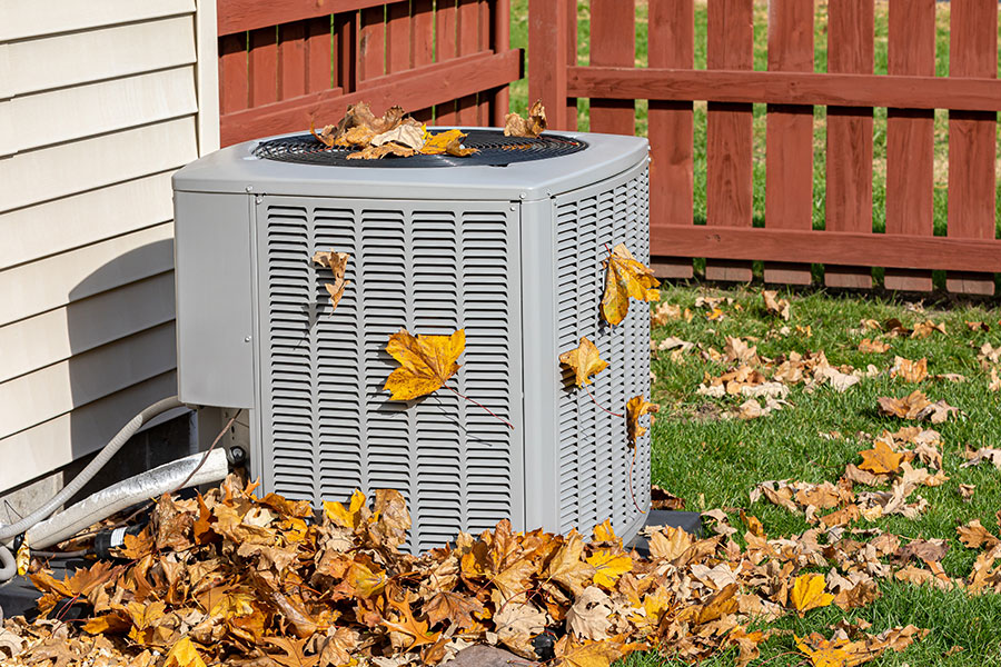 AC unit covered in leaves